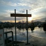 Sign at Eliason Harbor at sunset in Sitka