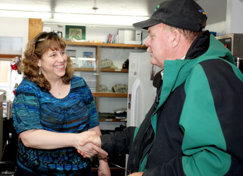 Theresa, the owner of Alaska Premier Charters, greets a client.